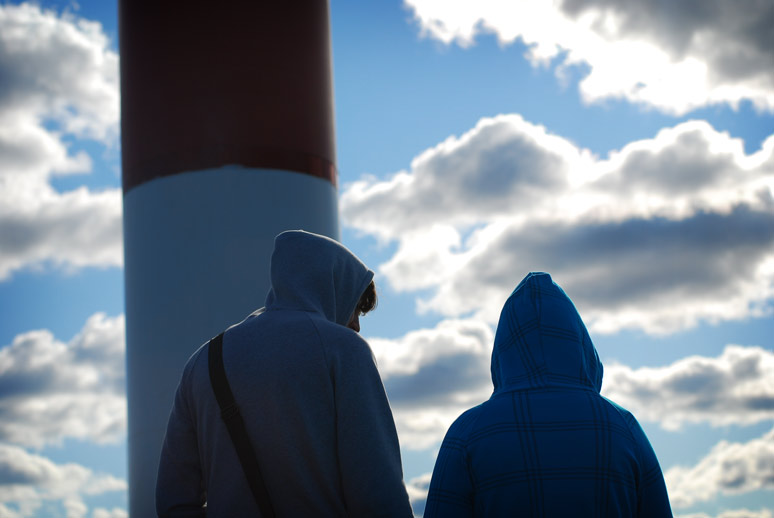 two people looking at a lighthouse